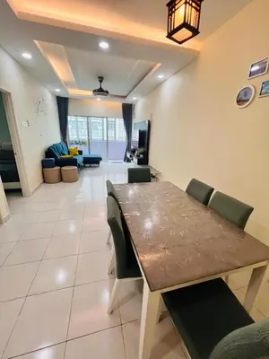 a dining room and living room with a table and chairs at Rayyan'Homestay PMCJ in Tanah Rata