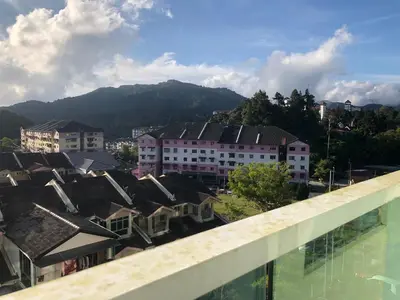 a view of a city with buildings and mountains at Rayyan'Homestay PMCJ in Tanah Rata