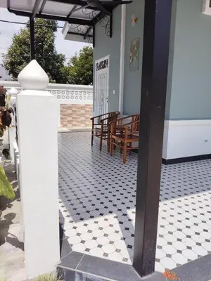 a porch with a white and black tiled floor at Makwan Homestay D in Kubang Semang