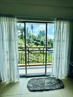 a room with a window with a view of a balcony at AYAAN ORCHID Fifa Home at Golden Hill Night Market in Brinchang