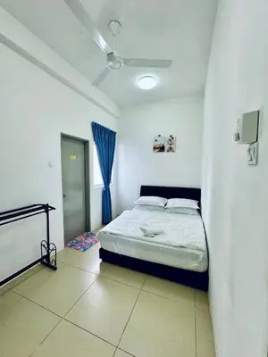 a bedroom with a bed and a ceiling fan at AYAAN ORCHID Fifa Home at Golden Hill Night Market in Brinchang