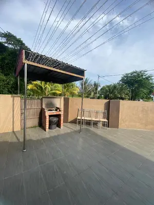 a patio with a grill and a table and chairs at Asu Homestay w Private Pool - Batu Gajah,Perak in Batu Gajah