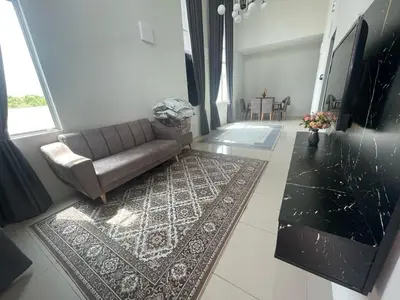 a living room with a couch and a rug at Tropika Homestay Ipoh in Ipoh
