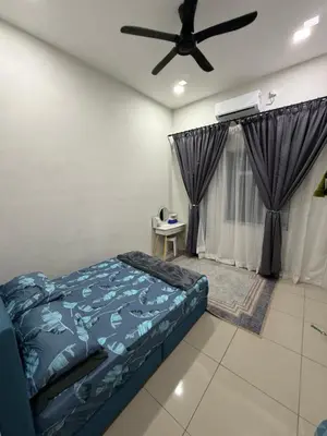 a bedroom with a bed and a ceiling fan at Tropika Homestay Ipoh in Ipoh