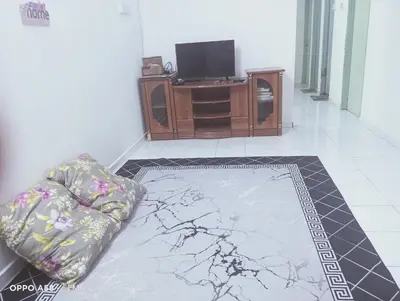 a living room with a couch and a flat screen tv at Homestay Bajet EM2 Pantai Remis 3 Room in Pantai Remis