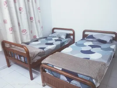 two twin beds in a room with curtains at Homestay Bajet EM2 Pantai Remis 3 Room in Pantai Remis