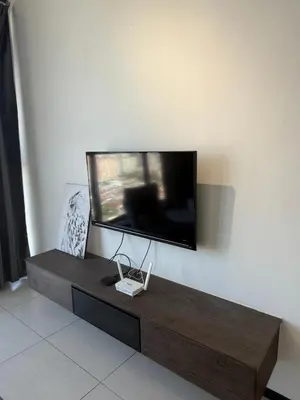 a living room with a tv on the wall at Urban Suites Home Suites by Twinkle Loft in George Town