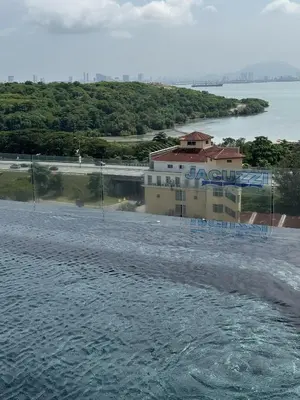 a building on the shore of a body of water at Urban Suites Home Suites by Twinkle Loft in George Town