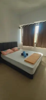 a large bed in a room with at Risma Homestay in Batu Ferringhi