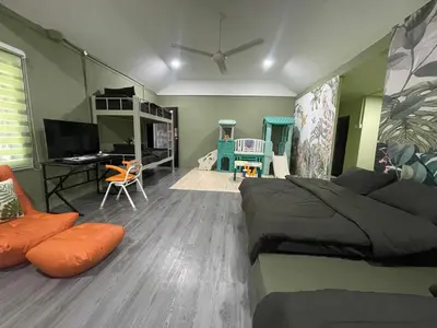 a bedroom with a bed and a desk with a computer at Kerlingfornia Pond View Homestay and Farmstead in Kerling
