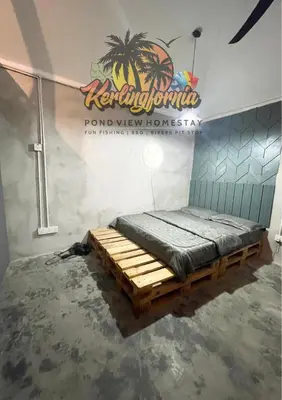 a bed in a room with a sign on the wall at Kerlingfornia Pond View Homestay and Farmstead in Kerling