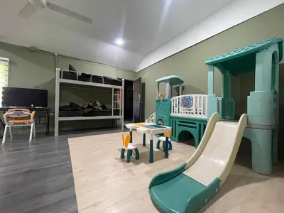 a play room with a slide and a bunk bed at Kerlingfornia Kiddo Kingdom in Kerling