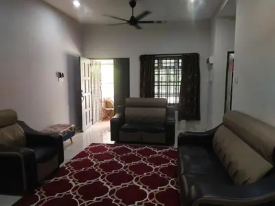 a living room with a couch and a chair at Teratak Desa Cemerlang 1