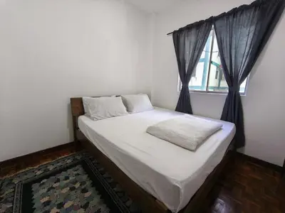 a bed in a room with a window at Puncak Cameron Holiday in Cameron Highlands