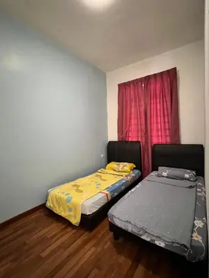 two beds in a room with a red window at Highland Breze Homestay in Tanah Rata