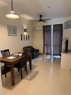 a living room with a table and a couch at Haven Nine Homestay in Batu Ferringhi