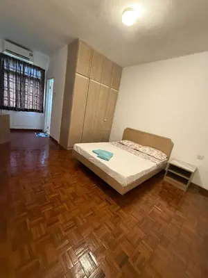 a bedroom with a bed and a wooden floor at Haven Nine Homestay in Batu Ferringhi