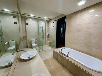a bathroom with two sinks and a tub and a shower at Marina Chic l Stylish 2BR Retreat l Straits Quay in Tanjung Bungah