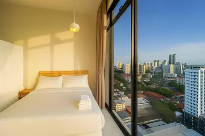 a bedroom with a bed and a large window at \u3010Lux\u3011HighFloor wi SunSet | Infinity Pool | KTV 207 in George Town