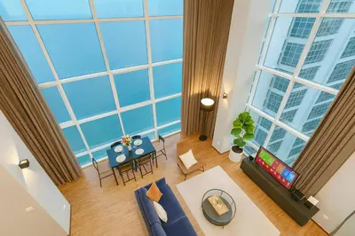 an overhead view of a living room with a large window at \u3010SeaView\u3011High Floor 2BR Duplex SeaFront-Town 21 in George Town