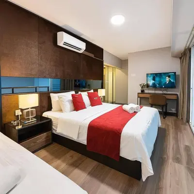 a hotel room with a large bed with red pillows at \u3010SeaView\u3011High Floor 2BR Duplex SeaFront-Town 20 in George Town