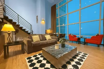 a living room with a couch and a table at \u3010SeaView\u3011High Floor 2BR Duplex SeaFront-Town 20 in George Town