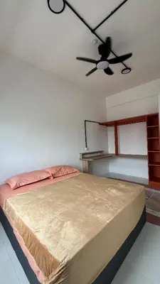 a bedroom with a bed and a ceiling fan at Teratak Burung Darimi in Kampong Bota Road