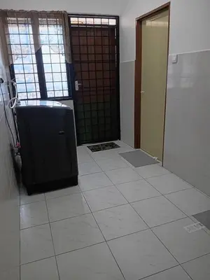 an empty room with a door and a tile floor at Balqis LN Homestay in Taiping