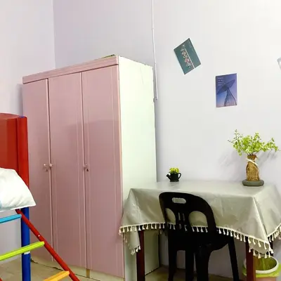 a table in a room with a pink cabinet at 10min near Ipoh Town Family Old & New Style 8Px in Ipoh