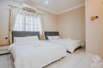 two beds in a room with a window at Luxe Retreat Homestay by Verve in Ipoh