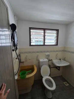 a bathroom with a toilet and a sink at Ipoh Stadium Hostel in Ipoh