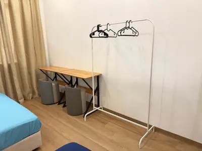 a room with a table and a bed and a desk at relaxing home in Bukit Mertajam in Bukit Mertajam