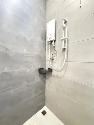 a bathroom with a shower with a toilet in it at relaxing home in Bukit Mertajam in Bukit Mertajam