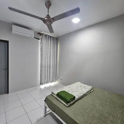a bedroom with a bed and a ceiling fan at Residensi Lourve Homestay Sungai Petani in Sungai Petani