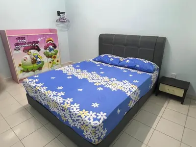 a bedroom with a bed with a blue comforter at Lake View From Bed Peaceful Getaway Home in Ipoh