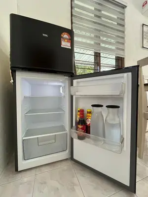 an open refrigerator with drinks and condiments in it at Santai DPermai Homestay in Selama