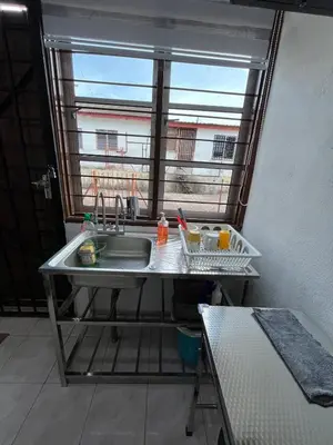 a kitchen with a sink and a window at Santai DPermai Homestay in Selama