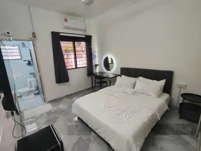 a bedroom with a bed and a sink and a mirror at sunshine bnb concept service in Ipoh