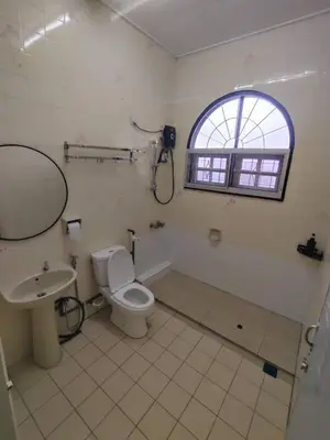 a bathroom with a toilet and a sink and a window at sunshine bnb concept service in Ipoh