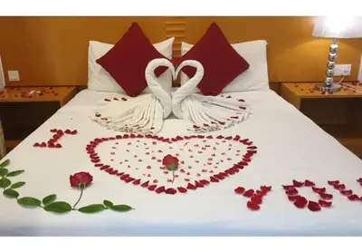 two swans made out of roses on a bed at Cameron Nova Highlands Resort V in Brinchang