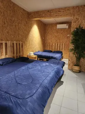 two beds in a room with blue sheets on them at Sun Vista Home by Ipoh Maju Stay in Ipoh