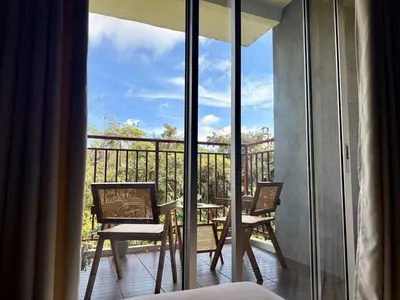 a room with a balcony with a table and chairs at Asa and Mori Japandi, Emerald Avenue, Brinchang in Tanah Rata