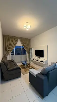 a living room with two couches and a flat screen tv at The White Mist Cameron in Tanah Rata