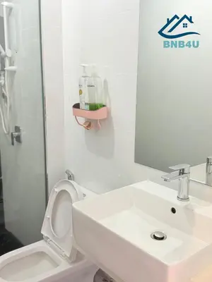 a bathroom with a sink and a toilet and a mirror at Beacon 2 bedroom at Jalan Sungai Pinang George Town Penang in George Town
