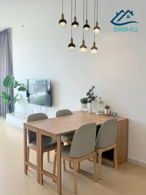 a dining room with a wooden table and chairs at Beacon 2 bedroom at Jalan Sungai Pinang George Town Penang in George Town