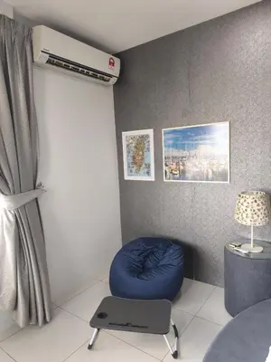 a room with a blue ottoman in a room at RoomB w attached bathroom w bathtub in George Town