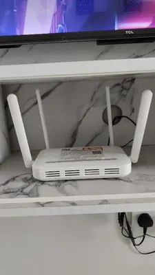 a white dvd player on a shelf with a tv at Sofea Stay Homestay Sungai Petani in Sungai Petani
