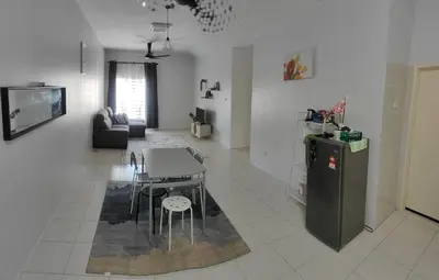 a living room with a table and a refrigerator at HS homestay Casa Klebang Ipoh in Ipoh