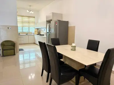 a kitchen and dining room with a table and chairs at 7BR Penang Stay Near Gurney and George Town in Tanjong Tokong