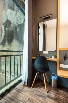 a desk and a chair in a room with a window at B Street Hotel in George Town